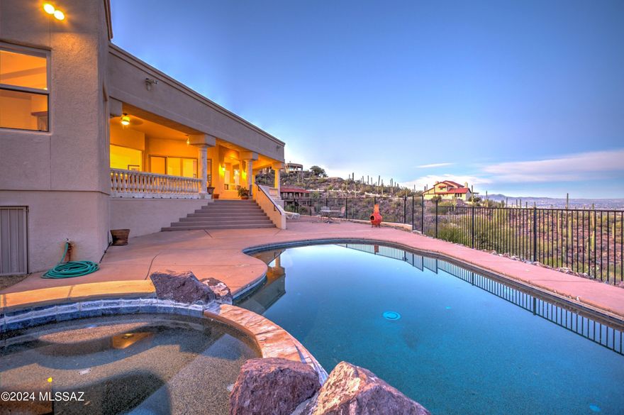 HAPPY JULY 4th!! Custom Built Home high in the Tucson Mountains in private gated community. LOCATION LOCATION!! Absolutely spectacular views of entire Tucson Valley, City Lights & Surrounding Mountain Ranges. Custom wrought Iron & glass double doors take you inside to beautiful columns, high ceilings & flowing floor plan from foyer to all living areas. Walls of windows bring in those gorgeous views. Well appointed kitchen w/double ovens, 5 burner gas cooktop, built-in-fridge,center island plus breakfast bar, large walk-in pantry AND breakfast table nook with views! Two living areas & 4 oversized bedrooms w/ private baths. Big Office/Den w/double doors & more mountain views. WOW factor! Even a Wrap-Around Patio!  Home should be seen in person to really appreciate it fully. Click on more... Make your appointment today!! Two living areas for large gatherings or quiet conversations. Formal dining room could always be used for another living area or even a Grand Piano! Window coverings in dining room and master bath have remote controls. Pebble-Tech Pool and Spa look out over the same panoramic views as seen from the deep covered wrap around veranda. Additional pavered patio area above the spa would make a great conversation seating area. Central Vac system, both dry and wet. Walk-in pantry off the Butler's pantry. Additional built-in cabinets, drawers and granite counter in the hall for west wing of bedrooms and bathrooms. 2 HVACs, 2 water heaters with recirculating loops. From the gorgeous sunrises to the setting sun, and the abundant wildlife parade, the indoor and outdoor living areas are created for family living or entertaining. The oversized 3 car garage has extended width and length, and the doors are wider than standard sizes to easily accommodate vehicles. Two large garage storerooms. Hilltop Custom Home built by Washburn Custom Builders, recipient of SAHBA Builder of the Year Award. Venice Wall Mural and columns painted by award winning artist, Annie Margarita.