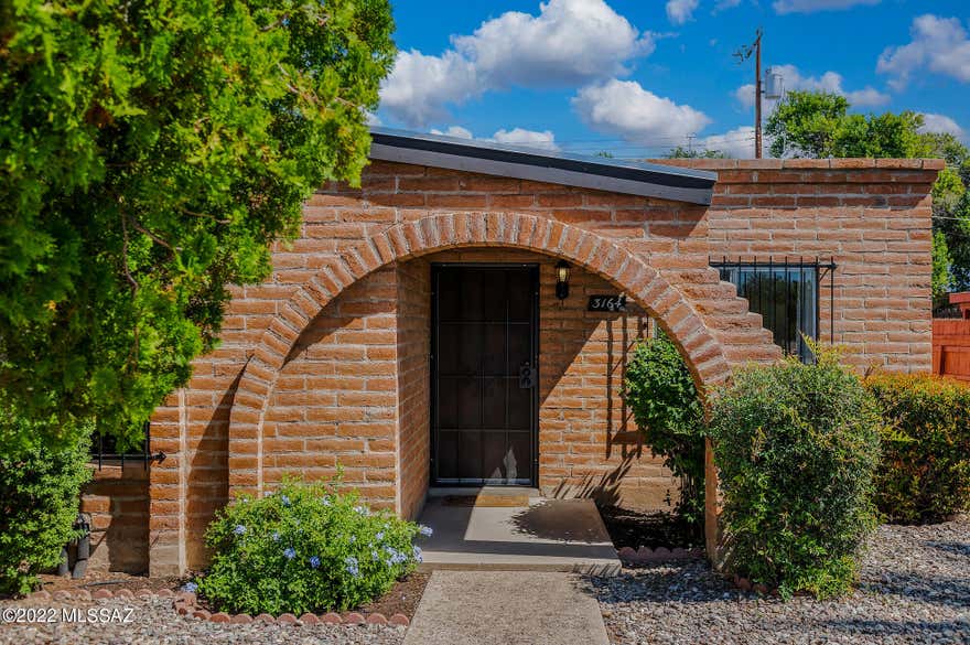 Welcome Home to this Adorable 2 Bed/2 Bath townhome w/Rustic Charm & Adobe Brick stamped ''mexico''.   Centrally located in desirable Spanish Village. Close to Shopping, Restaurants, Hospital, 10 min. to Uof A, 15 min. to downtown. Freshly painted Interior, Kitchen Cabinets,  Security Bars/Door & Gate 2022. Custom Kitchen Security Door & Back Door w/Internal Blinds & Pet door. Inviting Living Room fea. Built in Bookshelves & Wood Floors. Spacious Master w/Private Bath and Lrg Walk in Closet. Covered Back Patio w/Planter & Artificial Turf leads to Covered Carport w/Storage & Extra Parking. Short Walk to Pool & Rec Center. Laminate Plank Flooring in Bedrooms 2017/2022.  Adobe Brick sealed 2019, Roof 2019, HVAC 2022, Hot Water Heater  2017. Move in Ready & Appliances Stay! Owner Occupied Only