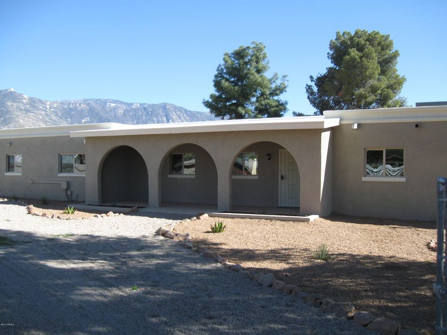 SUPERIOR QUALITY Built Adobe Ranch House. COMPLETELY RENOVATED inside & out!  AMAZING views of the Catalina Mtns.  New stucco over adobe brick exterior.  New paint in & out, new tile & carpeting, new kitchen with granite countertops, appliances & cabinets.  Remodeled bathrooms.  2 fireplaces with 1 in master bedroom!  New roof and new gas heat and AC. Has 2 septic systems. New dual paned windows throughout.  Square footage includes an attached casita with its own kitchen, bathroom, bedroom & living area with own separate entrance.  In ground pool that was re-plastered in a walled area for privacy. 3 separate fenced in areas for horse facilities and a hay-tackroom.  All flat useable land.  Great horse property & entertaining home!  This is one of a kind home. Has it's own water well