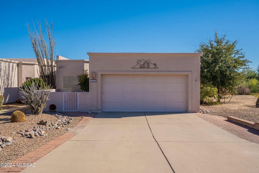 Embrace the Southwestern charm of this private end unit townhome that borders the common area.Located in one of the top retirement destinations in the U.S., where people come to enjoy the lifestyle and all of the amenities offered by Green Valley Recreation. As you enter the front door you will immediately be greeted with a colorful open living area that is showcased with tall ceilings, ceramic tile floors that run throughout the entire house and a gas fireplace perfect for those chilly winter nights. This 2 Bedroom , 2 Bath, with a den has a split floorpan that provides privacy for your winter visitors. The kitchen is adorned with white cabinets, white appliances, and granite transformation countertops. Come and enjoy the Santa Rita mountain views from your covered patio while enjoying your morning coffee. Welcome home to your new winter retreat!