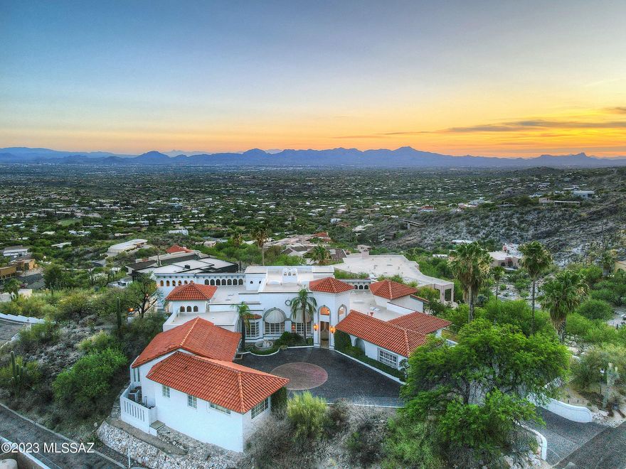 Introducing 5110 E Oakmont, nestled near the top of the prestigious Skyline Country Club neighborhood.  This stunning estate offers a luxurious living experience with breathtaking views. With its prime location, it provides the perfect balance of tranquility and convenience.  Step into a world of elegance as you enter this meticulously maintained and designed residence.  The spacious, over 7,000 square feet layout, boasts an abundance of natural light, creating a warm and inviting atmosphere.  The open concept living area seamlessly flows through to the gourmet kitchen making it ideal for entertaining large amounts of guests or enjoying quality time with loved ones.  Indulge in ultimate relaxation in the master suite featuring a private oasis complete with spa-like en-suite bathroom area. The additional bedrooms and bathrooms, including attached guest house, offers ample space for family members or guests, ensuring everyone feels right at home.  Outside the low maintenance and meticulously maintained grounds provide a private and serene escape from the hustle and bustle of everyday life.  Whether you are lounging by the pool, hosting a barbeque on one of the expansive patios, or simply enjoying the stunning views of the mountain and city lights, the space is perfect for creating lasting memories.  Located in the Skyline Country Club, residents have world class amenities nearby, including a championship golf course, tennis courts, and a clubhouse with fine dining options.  Additionally, the proximity to premier shopping, as well as dining and entertainment, ensures that everything you need is just moments away.  In addition to this incredible home, this list price also includes the lot to the east at roughly 1.2 acres that this home in the past has used as additional space for valet parking for large entertaining events and could be used for such still or perhaps additional guest house space or large car garage/museum, art studio, or any other additional space envisioned and dreamed of by its next owner.  Address of lot is 5120 E Oakmont and is listed separately as well but would be included at this price.