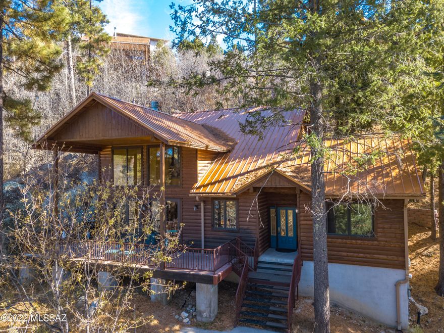 Year-round use cabin features a bedroom and full bath downstairs plus a private bedroom with full en-suite bath
and an additional sleeping loft upstairs, sleeping 8 or more comfortably. This 2-level cabin features a generously sized elevator as well. The lower level great room is ample with a dining area surrounded by glass doors leading onto an outdoor deck, a living room
with wood burning fireplace, and a secondary sitting area. The full sized kitchen has stainless appliances, a pantry, and an island with plenty of seating incorporated into the main living area. There is a large utility closet indoors, leading to a cellar with additional storage space. The concrete  driveway from the street has plenty of parking space, and the roads to this cabin are open year-round for residents... Convenient to Summerhaven town without experiencing the commotion of the main drag. The home sits on a total of 3 tree-studded lots with an abundance of privacy and quiet. This cabin is being sold turn-key so it's truly move-in ready!