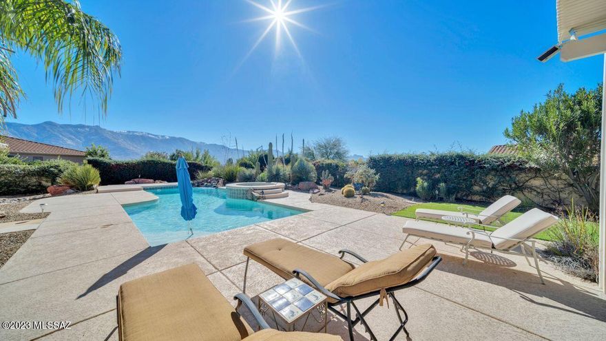 An absolutely dazzling home inside and outside! Enjoy a luxurious resort-like setting back yard to include an oversized lap pool, 2 ramadas, full BBQ with fridge, counter seating, outdoor speakers, rosebush garden, citrus trees, and extensive mountain views. Inside is a gourmet kitchen and a large island with bar seating. Beautiful 42'' cabinets, full backsplash, SS appliances, and gas cooking. You will love the open great room leading to the spacious covered patio. The grand entry leads to the living room with a cozy fireplace, charming dining room, soaring ceilings, and an exquisite staircase leading to guest bedrooms and bath. The master suite has a seating area, slider to the patio, and luxury bath. The 3 car garage has built in storage, a workbench, and pulldown attic stairs.