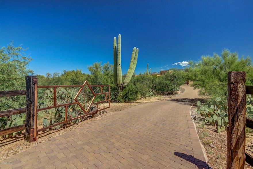 Custom built beauty w/unobstructed views of the Catalina & Tortolita mountains! You won't be disappointed when you walk into this highly upgraded home. The spacious gourmet kitchen offers knotty Alder cabinets, tons of granite counter space, double ovens & extra wide stainless built-in refrigerator. Large eat in dining area w/massive window to enjoy the breathtaking mountain views. Kitchen opens to huge great room w/beehive gas fireplace, custom rustic beams in ceiling & a massive window to enjoy the mountain views. Dining area has a rustic wooden beam entrance &  Coffered ceiling. Large bonus room w/ wet bar & sliding door to patio. Could easily be converted to second master suite! Split bedroom floor plan.  Over sized  laundry room w/knotty Alder cabinets, sink & room for a refrigerator The backyard is an entertainers paradise w/built-in gas BBQ, stacked stone Jacuzzi w/rock waterfall into pool. The house has a large covered patio & a viewing deck  to enjoy the mountain views & the starry nights. Don't forget to check out the over sized garage (25x24) plus a storage area. The lot offers beautiful vegetation, Saguaros & a  brick paver driveway.  Plenty of room to build an extra garage/workshop or add horse facilities.