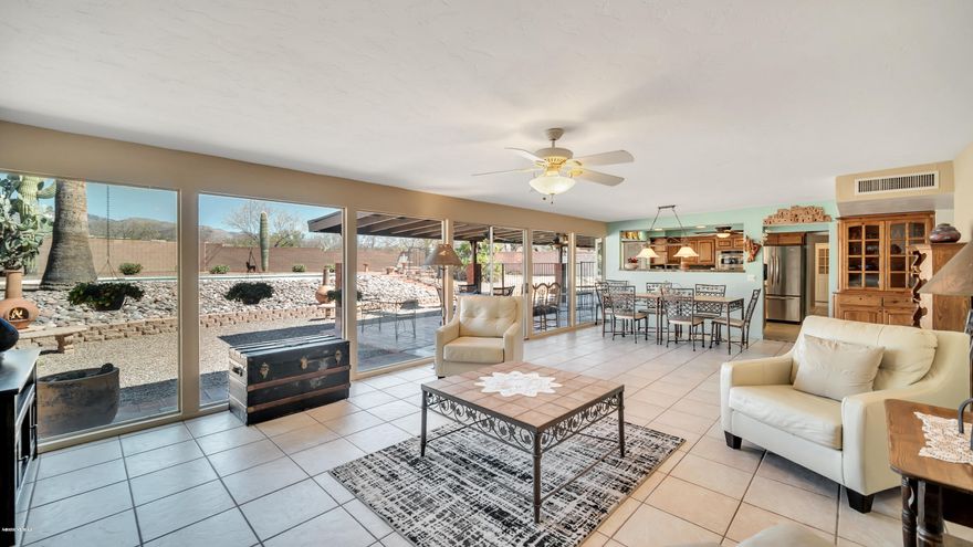 Wall of dual pane, tempered glass windows to enjoy outstanding mountain views while seated in front of the cozy, rock F/P w/built in TV/Sound system. Chef's dream kitchen w/5 lazy susans & beautifully upgraded. Master bath with nicely appointed tile shower & executive height dual vanity. 1+ acre lot contains solar heated pool, room for horse facilities, studded with palms & saguaros, all on a cul de sac lot with no thru traffic. Enclosed front courtyard - lots of privacy. Rec/game room with dbl sink, disposal, cabinets & refrigerator. Full RV hookup. 2017-18 - pool refinished & new equipment. Dog kennels behind garage can be removed by seller upon request. Concrete table & benches stay. Separate laundry room + additional washer hookup in garage. Large storage area in laundry room. Metal Fountain in front courtyard does not stay.  Don't miss seeing the large cleared area to the rear/side of the house - perfect for horse facilities.