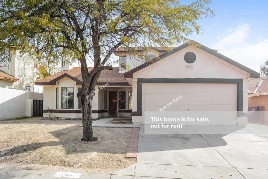 This Tucson two-story home offers tile and laminate flooring, a wood-burning fireplace, granite kitchen countertops, an office, a back deck, and a two-car garage.