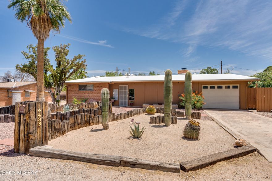 Beyond charming mid-century home in great central location! Vaulted ceilings with wood beams, walls of windows, open corner fireplace, abundant tile flooring. Large master bedroom with tile shower, walk in closet. Built-in bookcases in one bedroom. Open kitchen with glass front cabinets. Arizona room across front, extended covered patio in back. Large walled yard with extra storage/work area. Truly a must see property!