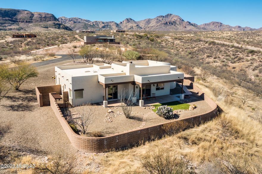 Southwest living at its best!  This authentic hacienda-style home sits on 4 acres of spectacular natural desert at the exclusive ''Ranch at Aliso Springs''.  Soaring high above Tubac, but just minutes away, this very special property has panoramic views that will take your breath away.  Embodying the warmth and spirit of the southwest, the home has high ceilings, a kiva fireplace, stunning rock work, tile floors, exposed beams, rustic hickory cabinets, eight-foot Alder doors and more.  The spacious owner's suite features a large walk-in closet, garden tub, separate walk-in shower, and private patio access.  The bonus room/den with separate access is the perfect artist's studio or office.  The oversized garage and laundry room provide plenty of storage.  All this plus a charming outdoor