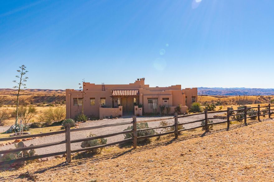SPECTACULAR mountain views out every window in this contemporary custom Southwestern home on 4.14 ac in beautiful Lake Patagonia Ranch Est. 4BD/4BA, 2599sf loaded with custom features. Split level w/Great Room, laundry, 2.5 baths,Master Bedroom and 2 other bedrooms, laundry room, deck & courtyard all upstairs. Lower level bedroom is perfect ''Man Cave'' or guest quarters, & opens up to a new flagstone courtyard & patio. 3 car garage & loads of storage. Well landscaped with fruit trees & attractive plantings. Enjoy all the recreational opportunities at nearby Patagonia Lake State park. Paved road and easy access to shopping & services. Enjoy a glass of wine & watch the sunset from the front courtyard or watch the glittering night lights from the Great Room deck.