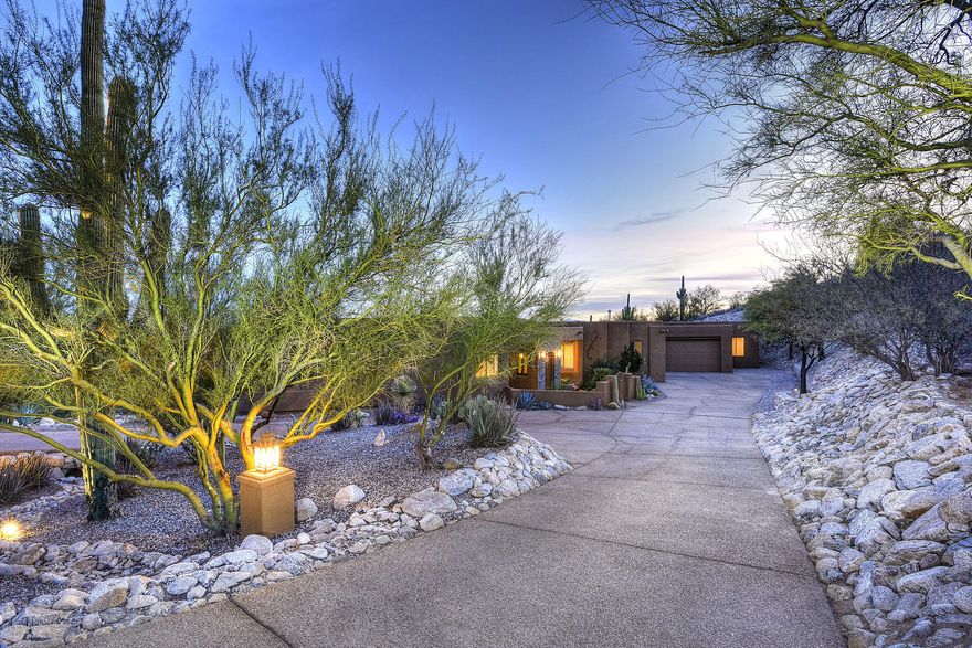 Gorgeous Home in Gated Catalina Foothills Estates 10 w/Mountain & sweeping city views. Single story, no steps! Enter from a circular driveway- plenty of parking & 4-car garage to boot. Home has 4 bedroom-5 bath w/an attached 891 square feet of workshop, art studio-man-cave-rec room-home theater or could easily be a lovely guest quarters w/half bath, separate office & zoned HVAC- you decide! Home has updated kitchen w/a fantastic center island, numerous dark wood walnut stained cabinets, Granite & Quartz counter tops, Dacor 5 burner gas stove, stainless Jenn-air double ovens,butlers pantry with more storage space & Samsung stainless Refrigerator/Freezer featuring water/ice in the door. Kitchen has such an open floor plan, it over looks the living room via a spacious breakfast bar for seamle