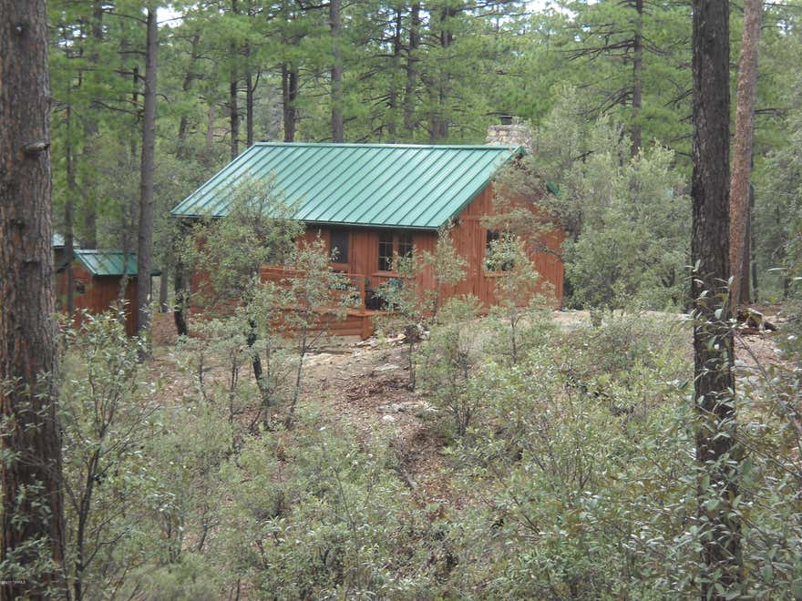 Great getaway from Tucson up Mt. Lemmon at 7,000 feet elevation**Located in the tall pines**45 minutes from Tucson**This cabin really looks and feels like a cabin with wood floors and knotty pine walls**completely furnished with nice furniture**Large fireplace with heatilator**3 fluid-filled baseboard heaters for low cost heating**Has an unfinished basement that can hold a water system, pump, water heater and more**A harvest-type water tank and system needs to be installed.  There is a shower stall outside the cabin**The cabin has an outhouse with a vault toilet**This is  a Forest Service area where you buy the improvements, and lease the land from the Forest Service**Call agent for Forest Service Lease information and any other questions.