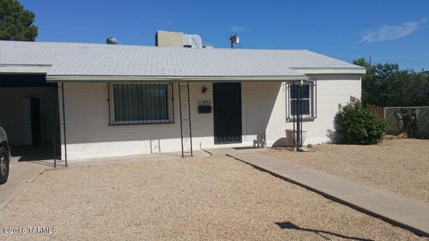 Charming mid-century bungalow with fresh paint,ceramic tile, new carpet in bedrooms.  Large fenced back yard with covered patio, double carport and storage room. Great location near D.M., Reid Park, shopping and transportation.