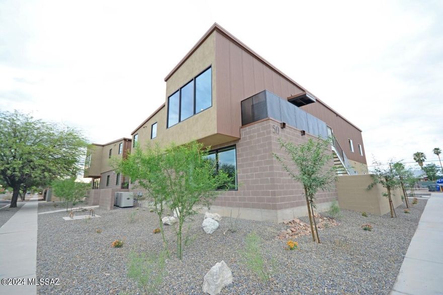 Rare opportunity to purchase newer construction within 3 blocks of UofA around a 8.06% Cap rate (proforma)! Seller Financing Available @6% for up to 5 years OAC with 30% downpayment. This newer building integrates metal roofing with block and stucco finishes for a really neat modern look that the students love. 4-plex, with 8bds/3.5bths per unit. Large units with huge common areas, all tile throughout, hardwood cabinets, corian counters, and ample appliances. Floorplan designed by afor students. Huge Picture windows in front frame nice mountain and city views. Large enclosed common area with Turf. Parking lot w 14 parking spots, 4 on street parking spots available, basketball hoops. This property is zoned for group homes and could be ideal for a variety of non-student housing needs.