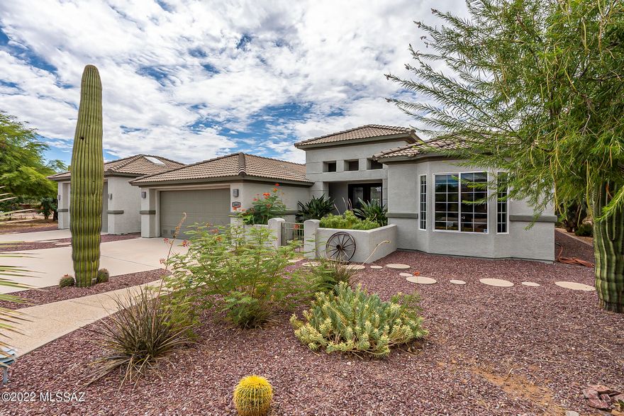 Take a look at this! A remarkable and contemporary custom-built, spacious home nestled on 1.12 acres with all the facets of country living possible yet within the city limits, and no HOA! Elegant porcelain glazed tile flooring greets you at the double door entry. Feel the quiet privacy of the roomy and inviting office/study, and two ample sized guest rooms with a joining bathroom. You really have to see this! The generously sized main bedroom features a gorgeous view of both mountain and desert with a separate entry to the covered patio and pool area. The kitchen is a perfect combination of functional and extravagant with handcrafted soft-close cabinets and drawers, ample granite counters, breakfast bar, dining room, and plenty of light... ...Beautiful scenic views of the mountains and natural desert landscape surround the entire property as you step outdoors to enjoy the pebble tec pool and landscaped back courtyard of citrus trees, walkways and luscious desert oasis, complete with a firepit with seating to enjoy the cooler Tucson nights. Relish your time in the delightful, covered atrium garden areas where multiple citrus trees and garden growing boxes can be found! The second detached two-car garage is ready for your workshop creations, with a 3/4 bathroom and climate control, or convert it into a guest house! Owned solar system with generator will keep you comfortable and keep the utility bills low! Live in the city and have your land too!