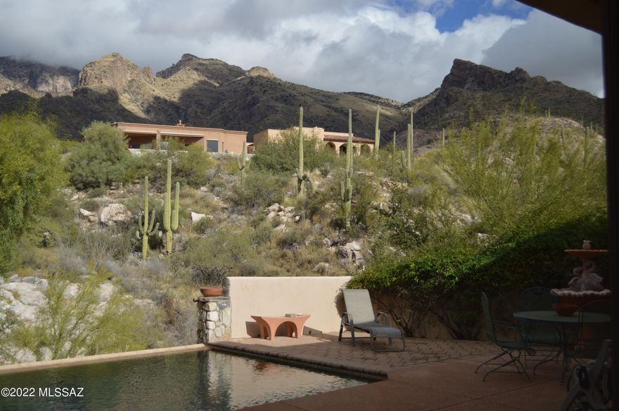 Stunning Catalina mountain views from this remarkable home located in the Summit at Finger Rock community. This home has a open floor plan with large picture windows, gourmet kitchen, spacious pantry, granite countertops and lots of cabinets. 4th bedroom is a casita with full bath, cedar lined closet and separate access from front courtyard. Bedrooms are generous in size and home has travertine tile throughout. Roof was recoated in 2022 and interior of home has been newly painted. The negative edge pool backs up to common area for added privacy. This home embodies all the views that Tucson has to offer and is a short distance to Finger Rock trailhead.