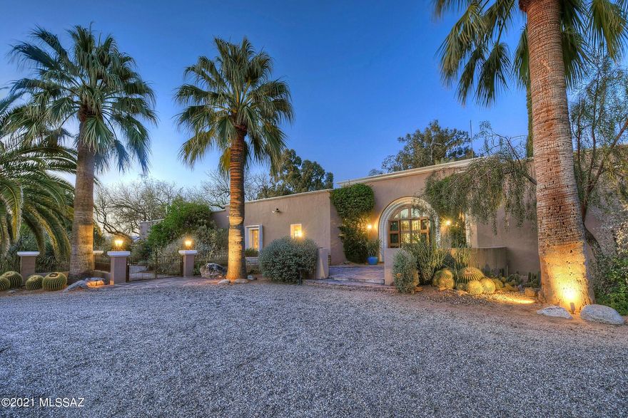 This magnificent one-of-a-kind estate on 7.5 AC w/Spectacular Mountain Views, Spanish Colonial Architecture & 2 guest casitas was built by renowned designer/builder Lewis Hall as his personal residence. This remarkable home boasts dramatic foyer w/ornamental gates leading into the elegant Liv Rm w/massive FP & huge picture windows, then a wonderful Sunroom w/wall of windows looking out to the bkyd oasis w/multiple patios, gardens, fountains, pool & those Views! Open dining area w/rich wood paneling & wetbar w/100 bottle wine cooler. Kitchen offers chiseled granite, 6 burner gas range & rich cabinetry. Spacious Owners Ste w/sky high ceilings, lovely FP & private patio w/spa & shower. Addl features include private well, owned solar, hobby room, concrete floors, 7 fireplaces & private gate.