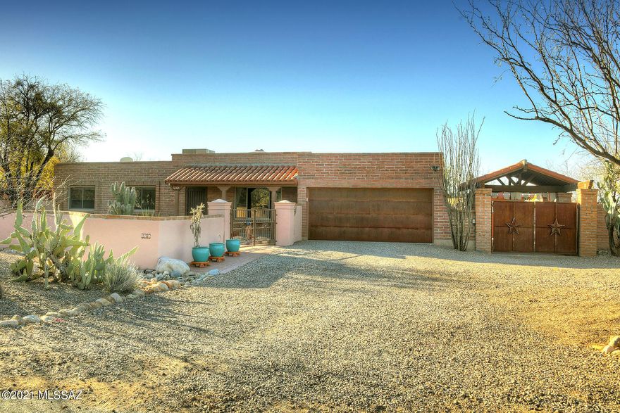 Charming burnt adobe home situated on quiet cul-de-sac in Tanque Verde Valley.  Great Mountain views greet you as you step onto the one acre property.  A large enclosed backyard has a salt water pool, putting green, chicken coop, rainwater catch system, and 2 double gates with access to the back yard, from front and back for additional toys. An additional masonry Ramada can be used as a carport in addition to the 2 car garage. House features Mexican tile flooring, wood ceiling and beams in living room, large dual sided fireplace and updated kitchen. Located near schools, shops and hiking. This house has been well maintained and offers a charming lifestyle.