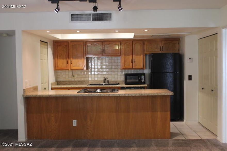 Lower Level two bedroom, two bath condo in prime location! Walking access to River Walk bike and jogging trail, Sunday farmers markets at Rilito Park. Close to La Encatada shopping center, U of A, downtown, St Phillips Plaza and plenty of restaurants. Community rec center and pool, spa, sauna, gym with equipment and indoor racquet ball court all located across the street from condo (currently under reno)  Interior features new carpet through out, large living space with fireplace. storage unit off master balcony. patio space off living room. All appliances convey. Dedicated parking spot included. HOA fee includes trash, water, pest control, security patrol, community pool, spa and gym, and exterior building and roof maintenance.