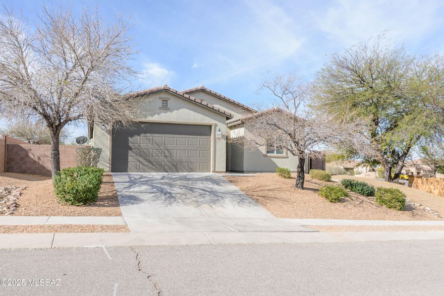 Seller will accept &/or counter offers between $333,788-$343,788.This meticulously maintained, original-owner 4 bedroom, 2bathroom home in Santa Rita Ranch sits on a corner lot w/ views of the Santa Rita Mountains. The split floor plan offers privacy & functionality, featuring a spacious open layout, 42-inch kitchen cabinets, a gas range, & an oversized laundry room. The primary suite includes a dual-sink vanity, walk-in shower, & large walk-in closet. A new water softener & recently updated carpet make it move-in ready. The low-maintenance backyard has an irrigation system, & the washer, dryer, & refrigerator convey. Special financing available for qualified buyers(little to no $ down). Located in the top-rated Vail School District, call to schedule your showing  & ask about incentives.