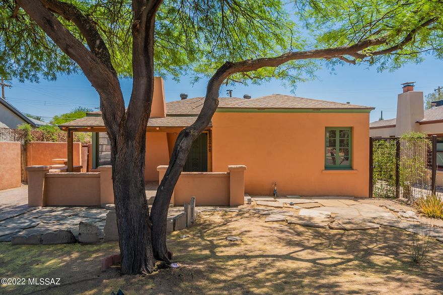 Absolutely charming 2BR/1BA bungalow in coveted Sam Hughes    The living room is spacious and features a lovely fireplace and wood floors.  Adjacent dining room is perfect for entertaining. The Kitchen features granite counters, a farm sink, a breakfast bar. Colorful Mexican tile vanity in the bath.  Multi-use Arizona room has separate new mini-split system.  Lovely back patio with stamped concrete, ramada and built-in BBQ, artificial grass is perfect for outdoor entertaining to enjoy the large backyard. Inside Laundry room with access to the yard. Custom wrought iron gates. One car garage is extra storage. Entire house has been rewired and all plumbing replaced.  Close and convenient to the University of Arizona, Himmel Park, Sam Hughes Elementary.  Very well-maintained and move-in ready.