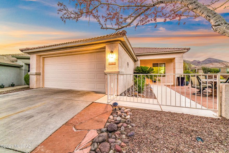 Charming Durango on a ¼ acre corner lot in The Highlands at Dove Mountain! Lush multi-level backyard features mature landscape of large trees, flowering bushes and saguaros. The putting green, water feature, extended patio with concrete pavers, mountain views and an endless pool/spa make this an entertainer's paradise! Spacious flagstone courtyard in front for enjoying your morning coffee. Spanish touches add character and warmth. Large windows and a wide foyer make this home so inviting. Ceramic tile throughout. Large master bath with 2 walk-in closets and dual sinks. Wonderful active adult community featuring golf, tennis, pickleball, pool and spa, fitness center, restaurant, pro shop, event center and more.