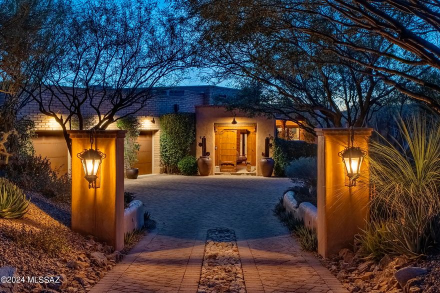 Located in the highly sought after community of The Estates at Honeybee Ridge. Set high on a premium view lot, this home is nestled within the lush natural desert landscape,  adding to the secluded feel of this estate property. An elongated veranda connects the shared living spaces, with a series of glass doors coordinated to tie the interior rooms to the spacious outdoor living environments, resulting in a perfect juxtaposition of private and social spaces.Layers of covered patios are perfectly situated to enjoy year round, with views stretching out over Pusch Ridge and the Catalina Mountains beyond. Native vegetation provides a seamless background to the manicured grounds causing an explosion of color, light, and shadow. Upon entry, you are greeted by a large Great Room with soaring ceiling heights acting as the central hall, inclusive of the formal living room to one side and dining, kitchen on the other, establishing the main connection point of the home. The private East wing of the residence features the sumptuously appointed owner's suite, with custom dressing closet and a luxuriously finished bath, including a large walk-in shower and soaking tub.

The floor plan comprises both formal and informal living spaces, equally suited for grand entertaining, as well as quiet moments, with a chef's kitchen where every measurement and detail has been carefully considered, boasting an oversized custom center island, designed to appear as furniture, complete with top-end fit and finish, including a La Cornue Grand Palais 180 range. Almost 6 feet in length, this handcrafted detail of absolute perfection is the crown jewel of the La Cornue | Château Series, commanding respect and admiration in any kitchen.

This private lot offers a series of patios and exterior living spaces designed for outdoor entertainment. The Southeast facing covered patio offers an outdoor kitchen, complete with a barbecue station, gas cooktop and sink with endless counter space and bar top. The veranda incorporates a masonry fireplace and covered dining patio, perfectly designed to the home's effortless blend of laissez-faire.

A succession of courtyards results in varied focal points, unwinding like a garden narrative of texture, light and mood. Every comfort considered and detail meticulously crafted, results in a home that offers a sense of easiness to enjoy both lifestyle and entertainment.

About the Area:

Honeybee is rich in Arizona History. The canyon that borders the west side of the development is called Honeybee Canyon. According to archeologists that have studied the area, the Native American Hohokam Indians discovered this area and were using Honeybee Canyon from the earliest of times.

Honeybee Ridge is a unique development consisting of 128 Custom Home Sites. The development is smaller than most of its competitors. No resorts, no high-density development, no golf courses, just a nice, quiet, peaceful place to enjoy Arizona living.

The Estates at Honeybee Ridge encourages its residents to be creative with high-quality materials and designs that are conducive to our wonderful landscape. When the development is complete, 128 custom homes will be built, all homes will be single-story, lot sizes are a minimum of one acre and design guidelines limiting disturbance to 16,000 feet per lot (not including driveway) will keep 75% of the development pristine & untouched.