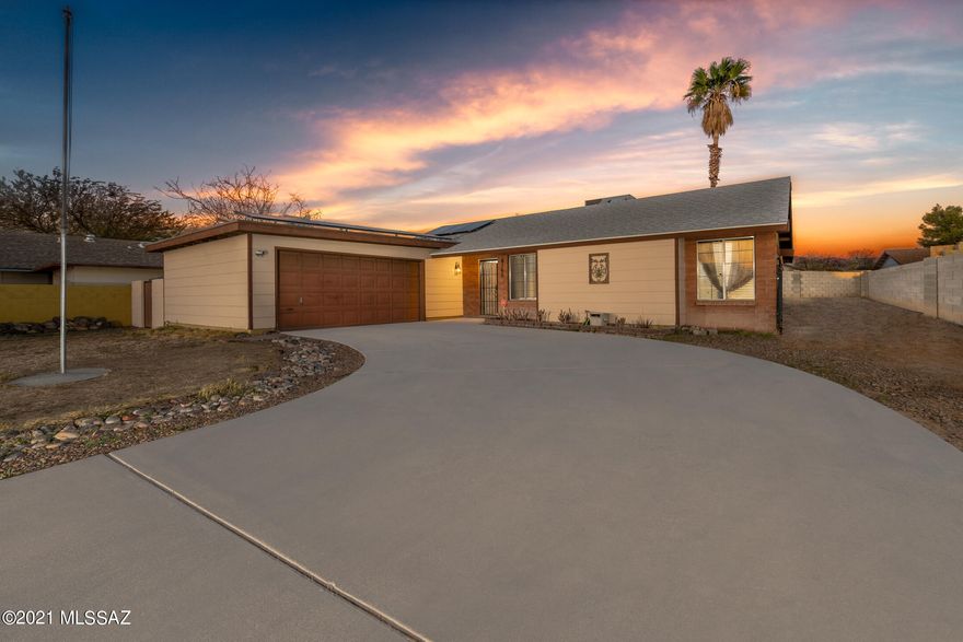 NO HOA!  NEWER roof and solar panels installed 8 months ago!  Cozy 3 Bedroom 2 Bath house with travertine tile through out the home, a nice fireplace in the living room, with a extended covered patio.  plus a extra evaporated cooler  for the garage area,. Sidewalks throughout the subdivision for a perfect evening stroll.  This home is within walking distance of a park with basketball court, tennis court and a big field area perfect for football, soccer or just having a nice picnic on the green grass surrounded by mature trees.