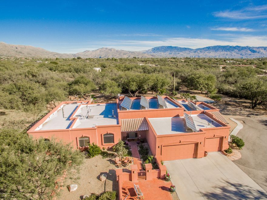 Gorgeous 6 BR 4 BA gated home tucked in the Sabino foothills, sitting quietly on 3+ Acres - feels like an estate. Lovely courtyard entry. Open Flexible floorplan with high ceilings, ultra plush Hay's Best carpet in bedrooms & beautiful natural travertine. Open style kitchen that opens to the family room and  resort-like backyard patio area. Huge pool with rock-like water feature & slide, Outdoor Kitchen equipt for TV and outdoor seating, built in gas fire-pit, half-basketball court and putting green. Beautiful grand master ensuite remodeled in 2015 boasts a spa-like ambiance w jet tub & large walk in closet. Playroom can be used as a home gym, home office, studio, theatre room or converted into a guest suite. Don't miss this home. Best value for size and features on the Northeast side!
