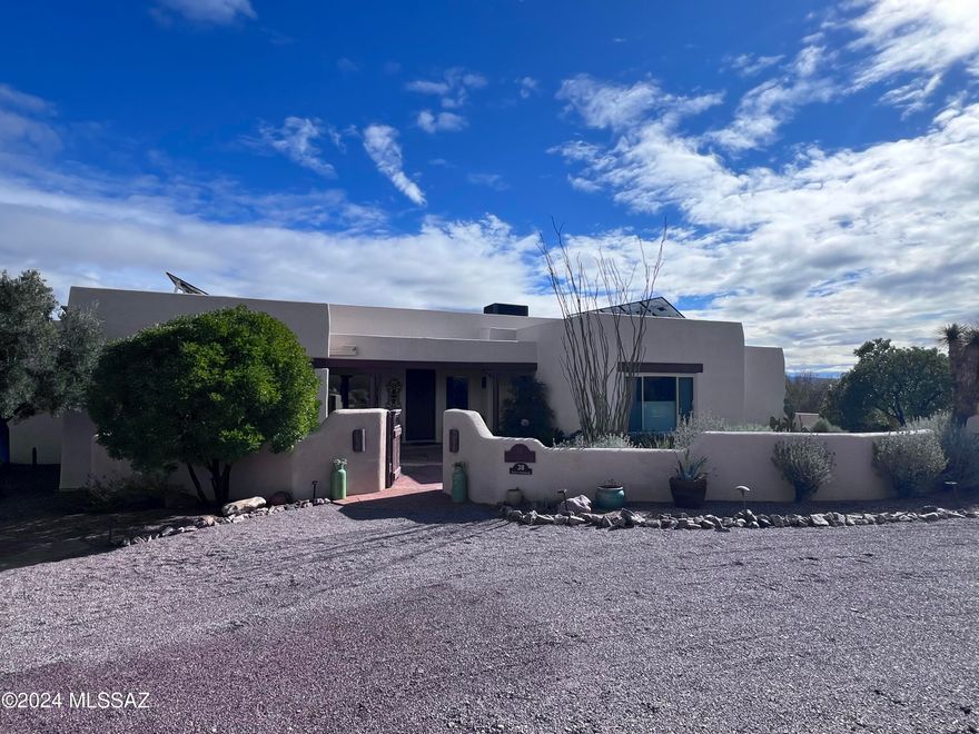 Ever changing blue skies call you to the windows of this beautifully maintained, comfortable, quiet home.  It has been built with energy efficient insulated concrete foam block and it also has solar installed.  Enjoy both sunrise and sunset expansive mountain vistas from this 2905sf split bedroom home that is situated on four acres, just two miles from the historic village of Tubac.  This home includes an attached spacious 3 car garage with epoxy coated floor and a mini-split.  No HOA or deed restrictions.  RV parking adjacent to the garage with 50 amp service and water.  Enjoy Southwest living at its finest.