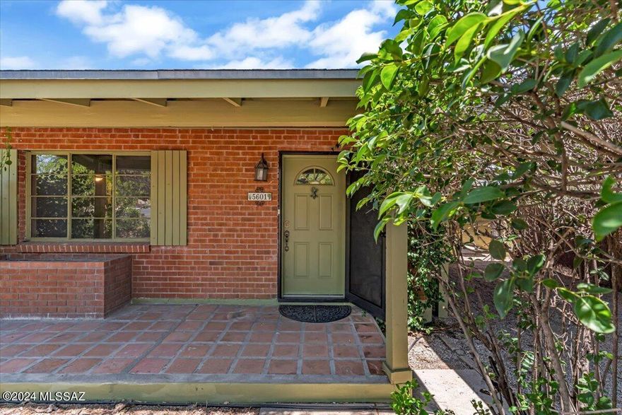 Gardeners Dream! Located in the popular Mitman area is a sage green and wire brick Tucsonesque Ranch home with a spectacular garden landscape front and back. Floor plan has been updated over the years to include a 3 bedroom 2 bath main area and the 4th bedroom has its own entrance off the side of the home. There is a separate sizable workshop in the back. Carport is an oversized architectural beauty all appliances convey including a secondary refrigerator in the laundry room. The backyard is a delight offering a small fish pond with lily pads all set up to run automatically. Tall trees for shade, pomegranate, grapefruit, Kumquat & Orange trees with abundant fruit surround the yard. Offering a 2-10 Home Warranty plan for acceptable offers. Don't delay make this home yours today!