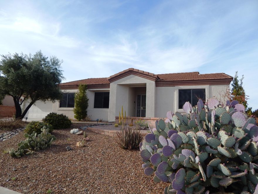 This beautiful San Ignacio Vistas home has stunning views out virtually every window! The home is perched high on a ridge above the San Ignacio golf course with panoramic views of the mountain ranges to the north and west. From the front patio, the living room and guest room you have excellent views of the Santa Rita Mountains. You will love the versatile floor plan with formal living and dining area and extended family room with neutral tile in all the right places. The exposed beam and built-ins give the family room a touch of character. The kitchen is open to the family room and has attractive stainless steel appliances. The laundry room is large with space for a desk, hobby area or storage. The master bedroom has a slider offering access to the patio and over sized backyard.