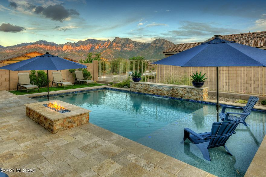 This 2020 Meritage build is truly exceptional in quality and finishes! Located in the heart of Oro Valley and close to amenities, yet tucked away in a quiet gated community on a .15 acre corner lot. This home boasts 4 Bedrooms/2.5 Bathrooms, 2342 sq ft, Chef Kitchen w/ quartz countertops, glass tile backsplash, SS Whirlpool appliances including gas cooktop, expansive island with bar seating and pendant lighting. Kitchen flows into the central great room w/ spacious dining room and slider backyard access. Upgraded 12' x 24' tile flooring run throughout the living spaces. The spacious Master Bedroom w/ spa-like bath truly encompasses an owner's retreat w/ oversized custom tile shower, separate soaking tub, executive height double sink vanity, quartz countertops, & sizable walk-in closet. There are 3 spacious guest bedrooms along w/ a full guest bathroom w/ executive height quartz countertops, dual vanity & shower/tub. Guest powder room accessible off entry hall. Enjoy the spectacular outdoor living from this professionally landscaped oasis. Features include covered & extended travertine patios, artificial grass pad, hot tub, sparkling pebble-tec pool w/ water feature, lagoon lounging & integrated gas fire pit all framed by the unobstructed Catalina Mountain views! Neighborhood features parks and trails to enjoy.