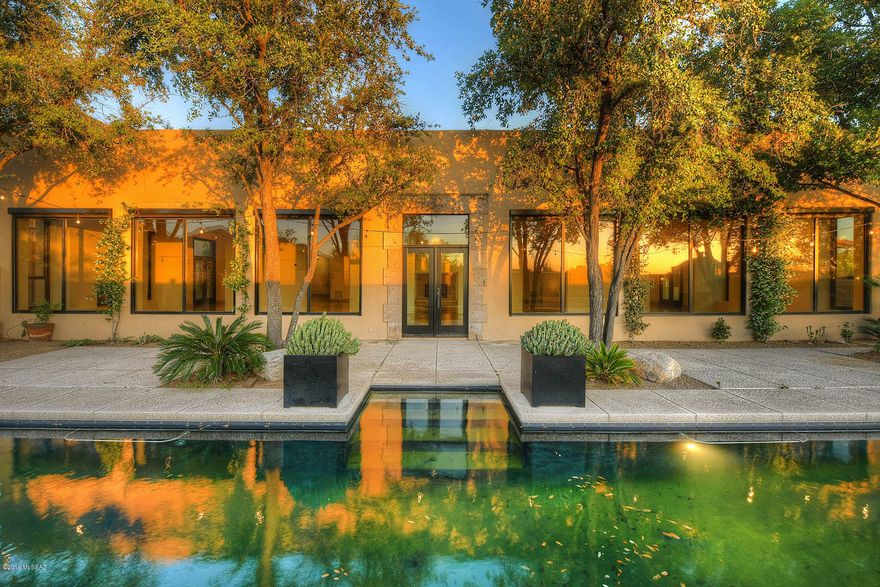 Santa Barbara & Contemporary Elegance blend inside a private, gated brick-paver courtyard, enter main house through a stunning custom contemporary steel & glass swing door, all new gleaming concrete flooring, gracious open floor plan featuring lofted ceilings, dramatic gallery living & family rooms, wall of windows, 3 fireplaces, entertainers eat-in kitchen,  master suite incl completely new master bath w/ slate shower wall & luxe fixtures, soaking tub, new (huge) master closet w/built-in laundry, split bedroom plan, home office/den, formal & informal dining space, fabulous expanded yard w/ new hardscape & wall enclosures, built in BBQ, gorgeous pool, spiral staircase to roof, full separate guest house w/living room, kitchen & bedroom, 3 car garage, patios galore, mountain & sunset views!