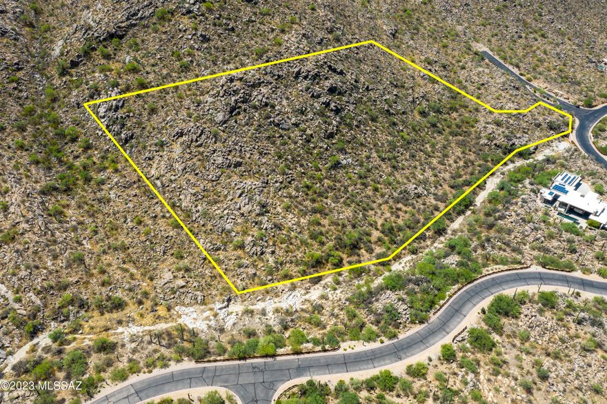 Mesmerizing location and views at this over 4 acre custom lot in Canyon Pass at Dove Mountain. Outstanding location within the subdivision on a corner - elevated lot - very spacious building envelope - lush desert landscape studded with saguaros, rock out-croppings.  Wonderful canyon views - panoramic vistas - sunsets that will awe.  Great value for this very large, very private custom lot.