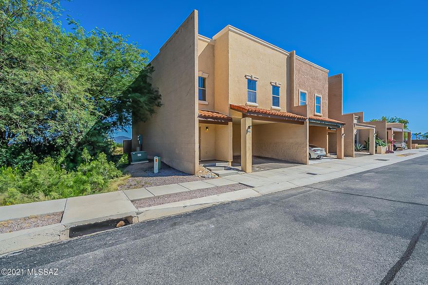 Adorable end unit townhouse located in desirable Santa Rita Villas backing to natural common area! 3 bedroom plan with soaring ceilings with lots of natural light, neutral colors, ceiling fans, newer carpet & ceramic tile floors in all the right places. Home hosts large living room with dining area leading to covered patio area, under stairs storage and lower level powder room. Master suite features balcony with mountain views, private bath featuring garden tub, separate shower, and walk-in closet.  Enjoy the neighborhood walking paths, picnic areas, clubhouse that offers a kitchen and pool table, the sparkling pool, spa and fitness center.  Conveniently located within minutes of I-19, shopping and schools!