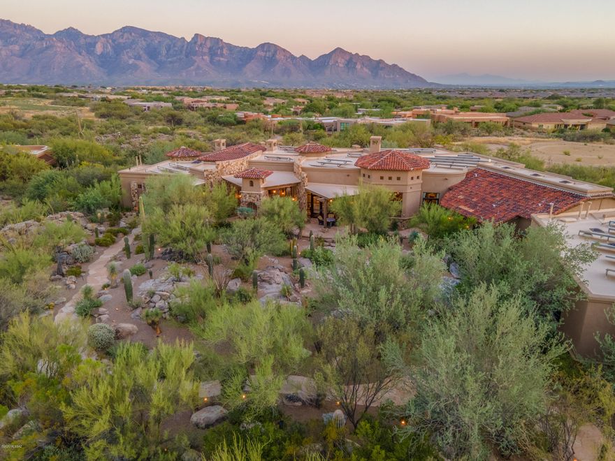 Meander your way to this stunning Romantic Italian Villa partially hidden behind desert & boulders. As you approach the home you are welcomed by a stream of water flowing under the bridge leading you to grand antique front doors. The foyer lavishly surrounded by stone walls, ripple barrel vaulted ceilings lined with bricks and beams. Library/Office features alder wood beam ceilings, wood paneling, curved stone walls and unique parquet pattern wood floors. Spacious master suite  designed with a luminous grey palette inspired by carved Carrara marble fireplace repeated throughout the suite in silk taffetas and velvet furnishings. Mirrored chandeliers, columned canopy bed and antique floors transition you into the the marble covered master bathroom. Solid Carrera marble tub, vanities, floor and walls. 9' circular double shower features mosaic floor and stone paneling.  Roman inspired architecture can be found in every room. Three additional gracious guest suites with private patio areas. Glamours dinning room setting complete with stone curved wall, outdoor patio access, wood floors and distressed beams against painted coffered ceiling.  Grand living room space extends to cozy seating space near one of many fireplaces and full bar for the entertainer. Bar fully stocked with commercial ice maker, microwave, dishwasher, sink and plenty of bar top space for all to gather. An ingenious raised intimate casual secondary dinning area off the living room allows for a full view and easy access to the adjacent temperature controlled wine cellar. The Italian farm house kitchen features a 17' beamed ceiling, clerestory windows, rustic finishes, hand painted glass wall cabinets and a butlers pantry. Elegant book case media center, handcrafted tiles, silk covered furnishings, distressed beams, painted coffered ceilings are just a few luxuries you will find in this incredible home that truly welcomes and inspires. 

Property is presented and sold furnished. List of items not conveying will be provided.  

Home is Solar Powered - Owned Solar Equipment

Matterport Video Tour Available 

Under Documents Tab - Floor Plan is available

Video Coming Soon!