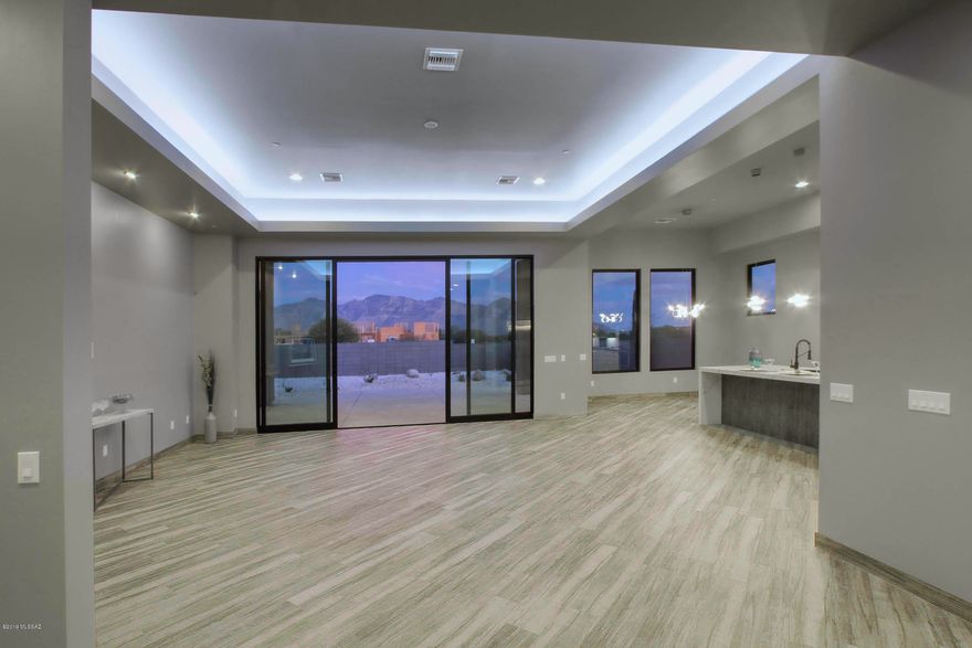 Stunning Brand New Contemporary Home setting on nearly 1 acre. 2871sf 3 Bdrm 3 1/2 Bath  open design concept. Quality Craftsmanship throughout this custom home includes many special features. Plank Diagonal Tile flooring throughout, Wall of windows including 10/16' Slider with Catalina Mtn Views, Designer Kitchen with Stainless Appliances including built in refrigerator/freezer. European style cabinets, Quartz counters with waterfall edge island & Walk in Pantry,  Master Suite includes Luxurious  Bath with double vessel sink vanities, large soaking tub,  walk in shower, plus large walk in closet with access to laundry.  Large Laundry room with loads of cabinets, and sink. Oasis walled back yard with large covered patio with access to roof top deck. This unique  new home is a must see.
