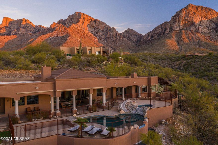 ** BACK ON THE MARKET!** Views of twinkling town lights, vistas across Northwest Tucson including Sombero Peak and the Tortolita Mountains. Plus dramatic Pusch Ridge rock faces that feel like you can reach out and touch them. Entertain under 1971 sq ft of covered patios. 8ft alder doors & rustic travertine floors. Tasteful European feel kitchen with Wolf appliances. Guest quarters w/ sitting room kitchenette and separate entrance. Large jacuzzi tub & fireplace in master retreat with office/exercise area. Custom owned solar array. Just imagine making your memories in this stunning one-of-a-kind setting.