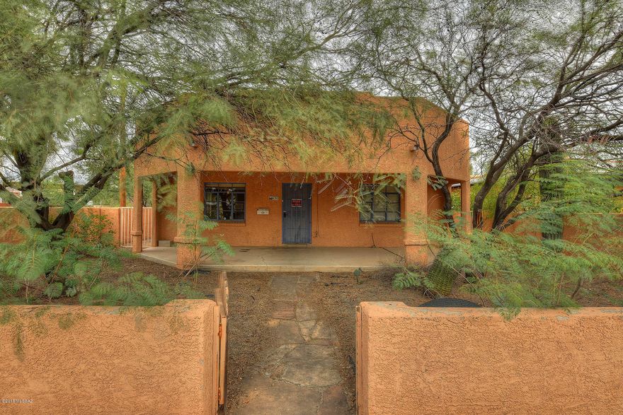 Sam Hughes home with a guest house.  4 bedroom 3 bathroom home.  Hardwood floors throughout.  Living room/dining room, newer kitchen with granite counter tops open to Family room and large covered patio and back yard.  Separate guest house has 660 sq feet,  1 bedroom 1 bathroom separate guest house with tiled floors .  Plus a large 2 car garage with plenty of room for a  work shop or extra storage.  Walking distance to  Elementary school,  the Rincon Market, Himmel Park and the U of A.