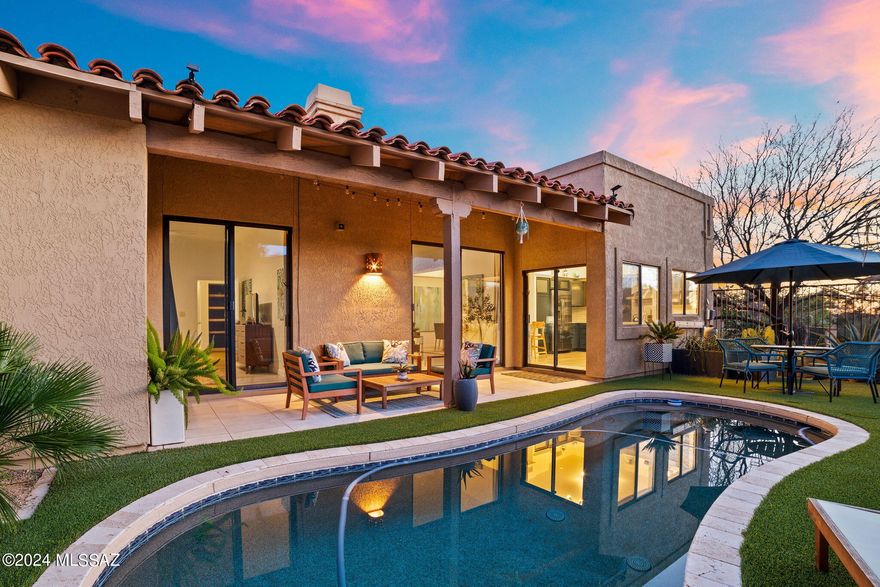 A true Sonoran Desert Oasis. This stylish modern home on the 3rd tee box of Pusch Ridge Golf Course has been fully updated inside & out by a professional design team for their personal retreat. The space is light, bright and airy with expansive glass doors, windows, skylights & natural light paired with white oak wide plank LVP floors & crisp white walls. Included bamboo shades & curtains are blackout lined for energy efficiency and privacy. Open concept living/dining/kitchen with 10-ft ceilings, stylish marine blue cabinets & quartz counters flanked by new stainless appliances create a welcoming environment for entertaining. Enter the primary suite via double doors to enjoy the quiet luxury of a spa-like bathroom, large bedroom with pool access, walk in closet & plethora of storage space The 2nd bedroom is perfect for a home office and features a very comfortable new queen size sofa bed for guests. The 2nd full bathroom mirrors the primary with its marble and glass tile and floating vanity. The home has a separate laundry room with additional storage, and locking storage in the epoxy floored
2 car garage. Indoor/Outdoor living is encouraged with the pebble-tec pool surrounded by travertine and limestone patio as well as turf that provides a stunning visual contrast.
The low-maintenance xeriscape landscaping provides a resort like feel using a tasteful collection of palms, cactus, and agaves. This home is truly turn key - fully furnished with designer pieces from Crate & Barrel, West Elm, All Modern, Pottery Barn, as well as a Crate & Barrel stocked kitchen. Perfectly located at the base of the mountains with shopping and dining just 5 minutes away.