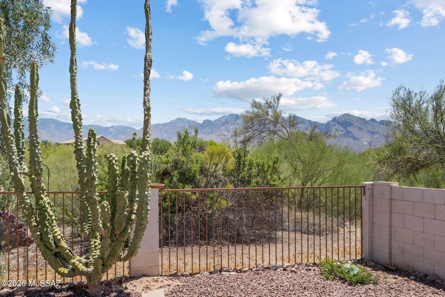Welcome to Canada Hills! Enjoy breathtaking, unobstructed views of Pusch Ridge, the dramatic westernmost edge of the Catalina Mountains. This beautiful 3-bedroom, 2-bathroom home backs to a pristine common area (maintained by the hoa) and the 14th fairway of the El Conquistador Golf Course. The kitchen features a premium Bosch gas range and dishwasher, complete with a wraparound breakfast bar perfect for entertaining. Inside, find a charming fireplace with a custom mantle, upgraded windows throughout, and fresh exterior paint. Complete with a 2-car garage and storage galore. Located just minutes from top-rated schools, including Wilson K-8 and Ironwood Ridge High School.