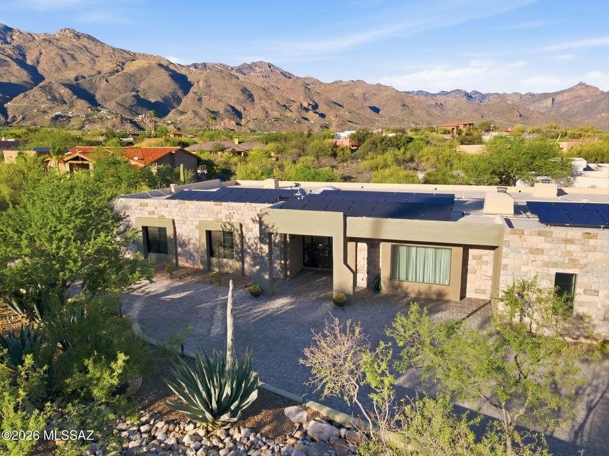 Where Architectural Flair meets Beauty and Serenity. A Modern Contemporary design by Ron Robinette with privacy, views of the Catalina Mountains.  A Chef's Kitchen with Italian Appliances, a cascading quartz water fall design Breakfast Bar / Pre Area, as the center piece of the Kitchen. A luscious and luxurious Primary Master Bath & Suite, Fireplace and views, three spacious Guest Bedrooms with one offering an ensuite, perfect for Guests. Energy efficiency with Solar panels, a versatile Bonus Room and a generous 3 Car Garage with EV Hook up.  An effortless transition from House to Desk to Back Yard sanctuary.