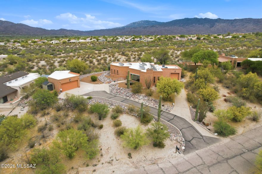 A standout feature of this 3 Bedroom property is the separate Studio with a full bathroom--ideal for an artist's retreat, yoga space, home office, or guest quarters.  Nestled in a desirable eastside location, this exceptional property is an off the beaten path hidden gem yet close to all city amenities.  Enjoy breathtaking panoramic views of the desert landscape, Catalina and Rincon Mountains, and stunning sunrises right from your own backyard. Relax on the tranquil patio as you take in the natural beauty that surrounds you. The beautifully maintained grounds feature mature desert landscaping, iconic saguaros, and a charming lemon tree, creating a serene and picturesque setting. Enhancing both comfort and efficiency, the home is equipped with solar power and an EV charger. Inside, the home showcases high vaulted tongue-and-groove ceilings that add warmth and character, along with a custom wet bar complete with a wine cooler--perfect for entertaining. The upgraded kitchen boasts modern counters and appliances designed for both style and functionality. Additionally, the third garage bay includes built-in cabinetry and offers flexible use as a home gym, workshop, or craft space. Unwind in the outdoor sauna after a long day and embrace the peaceful lifestyle this unique property provides. This one-of-a-kind home truly captures the essence of desert living with modern conveniences--don't miss the opportunity to make it yours.