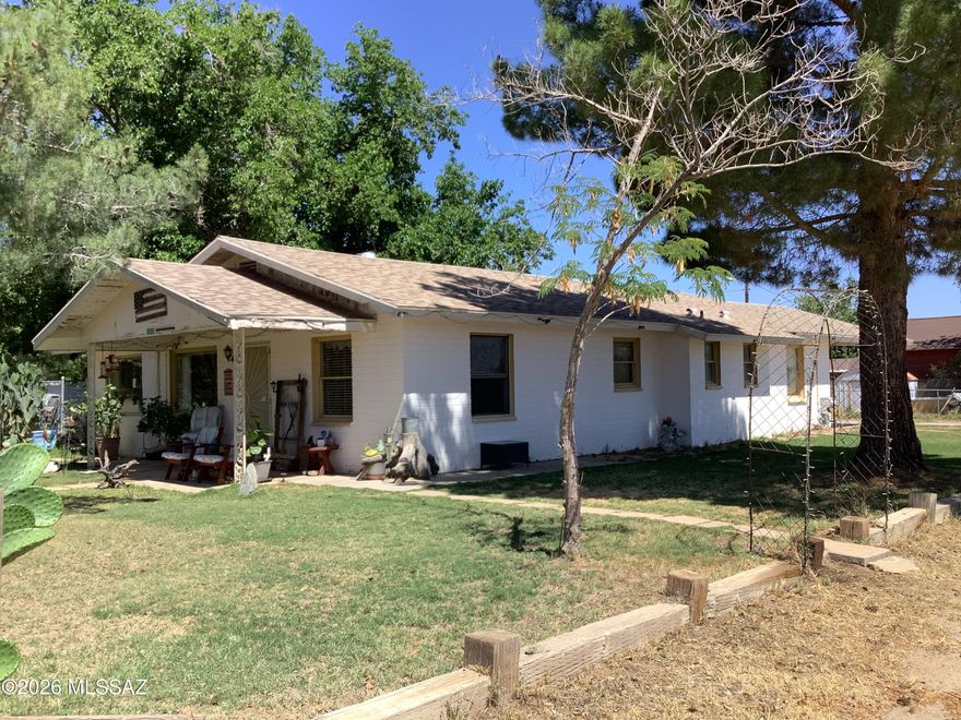 Here is a 2-bedroom, 2-bathroom house on a double corner lot with a carport, front & side covered porch and 2 sheds within a fully fenced backyard. Open concept living and dining room with lots of windows to let the light in and ceiling beams to give it character. The kitchen is right off the dining room and has a second entrance from hallway. It features a built-in desk area with unique curved wall. The large laundry room has plenty of built-in wall storage and a door to the nice sized covered side porch. The guest bathroom features built-in cabinets and vanity with a tub/shower combo. A large guest bedroom with large closet. The primary bedroom has a primary bathroom and its own door to the outside & carport. Double corner lot with grass and trees in front and back & RV Parking too.