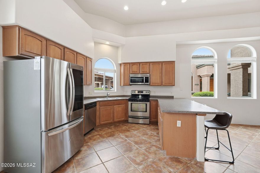 This elegant single-story townhouse is located in the Tucson Mountain Sanctuary. Upon entering, you will find a stunning great room with high ceilings and an open kitchen complete with all appliances. The townhouse features three bedrooms and two full baths. Enjoy tile flooring throughout, with new carpet in the bedrooms, an enclosed sunroom, and a front patio to enjoy the weather. The well-maintained community includes a pool and is conveniently located near shopping and schools, and is just minutes from the University of Arizona, Pima West, and major highways I-10 and I-19. This property is a must-see!