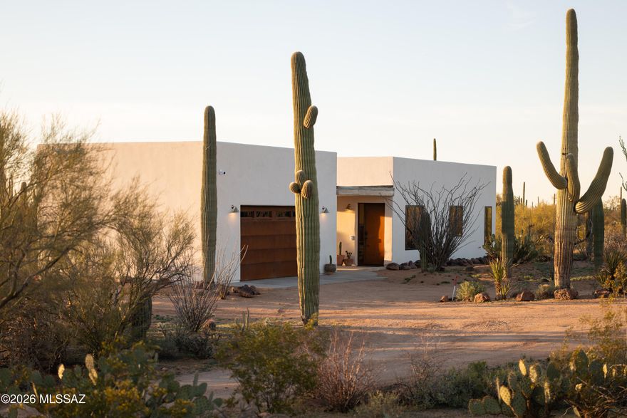 A new build nestled into the Sonoran Desert on Tucson's Westside. Eight acres of space, silence, and sky, with sunset views and long sightlines toward Saguaro National Park. Built in 2025, this is a property shaped around connection to land, to light, and to the easy rhythm of indoor and outdoor living. Tucked down a long dirt road, arriving home feels like a true retreat.

The main residence is 2,373 SF with 3 bedrooms and 2.5 baths, designed for easy daily living and effortless hosting. At the heart of the home, the kitchen island anchors the plan, made for gathering, conversation, and slow mornings that stretch into the afternoon.

A separate structure includes a 2-car garage and an 825 SF casita with 1 bedroom, 1 bath, and a living area, ideal for guests, creative work, or extended stays. Close enough to feel connected, separate enough to feel like its own hideaway. Both the main house and casita open to covered patios, extending living space into the desert and making the most of Tucson's best seasons.

A commitment to performance is evident throughout: insulated walls with ZIP exterior insulation and rainscreen, a 30-year three-layer roof system, triple-pane windows, a 20 SEER HVAC system, high-efficiency hybrid electric water heaters, and a fully insulated garage with its own mini-split.

Set near the Desert Museum, Saguaro National Park West, and JTH Tucson, this home offers immediate access to the landscape, miles of hiking, cycling, and riding trails, wide-open horizons, and the kind of quiet you can feel. With a separate casita and generous acreage, it is a natural fit as a primary residence, a multi-generational compound, or a flexible setup for guests and potential income generation. An elevated 9' x 16' pool is an ideal perch for sunset swims and star-filled nights.