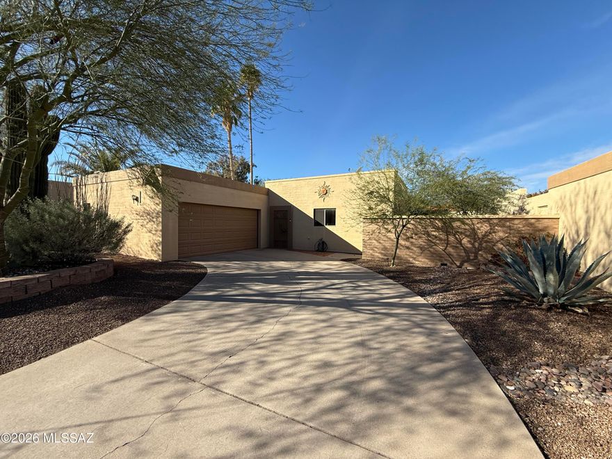 This charming 3-bedroom, 2-bathroom single-level home offers 1,401 square feet of comfortable living space in the desirable Fountain Park community. The galley-style kitchen features solid wood cabinets, tiled countertops, and a matching backsplash. The cozy living area includes a fireplace and a light-filled atrium that brings the outdoors inside. The primary bedroom offers a walk-in closet and an updated ensuite shower, while the additional bedrooms are well-sized and share a full hall bath. A bonus 98-square-foot Arizona room overlooks the beautifully landscaped, low-maintenance backyard, complete with an extended flagstone patio, raised planter beds, a shady mesquite tree, and a hot tub with slider access from the primary bedroom. The home includes a two-car garage with additional storage space. Community amenities include a pool, park, playground, and scenic walking paths--all within a peaceful, established neighborhood conveniently located near shopping, dining, and schools.