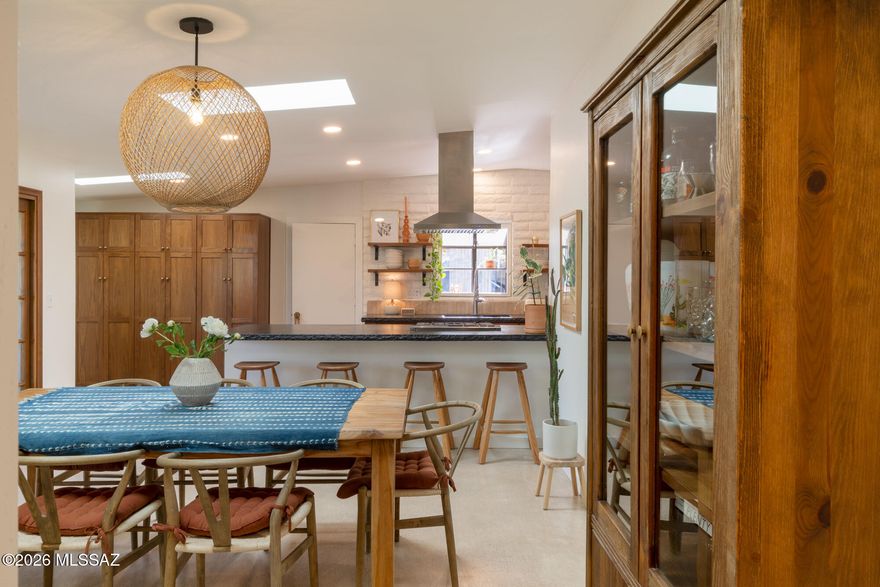 Charming ranch home near Sabino Canyon Recreation Area with mountain views, privacy, lush native landscaping, and effortless indoor-outdoor living. Set on over a third of an acre, this thoughtfully reimagined property offers multiple outdoor spaces to gather, relax, and enjoy the desert lifestyle, complete with a sparkling salt water pool just in time for summer.

Enter through double doors into a welcoming courtyard with flagstone walkways, native plantings, pergola, fountain, and views of the Catalina Mountains. Inside, the 3 bedroom, 2 bathroom home spans 1,764 square feet and has been updated throughout by the current owners. The dining room and kitchen open directly to the courtyard through glass double doors, creating a seamless connection between inside and out. The generous living room features a fireplace and opens to the rear patio and pool area beyond, filling the home with natural light and an easy connection to the surrounding landscape.

The backyard feels like a private desert retreat, with mature landscaping, shaded lounge areas, and a detached cabana tucked among the gardens. A 2 car garage and additional 3 car carport provide ample parking and flexibility.

Recent improvements include polished concrete floors, updated landscaping and irrigation, skylights, new exterior doors, cabinet refacing with solid brass hardware, outdoor steel privacy screens, pergola, awnings, garage improvements, and more. The roof was recoated in 2025, with meticulous maintenance and thoughtful upgrades completed throughout ownership.

Ideally situated near neighborhood schools, hiking trails, and the everyday amenities of the Foothills.