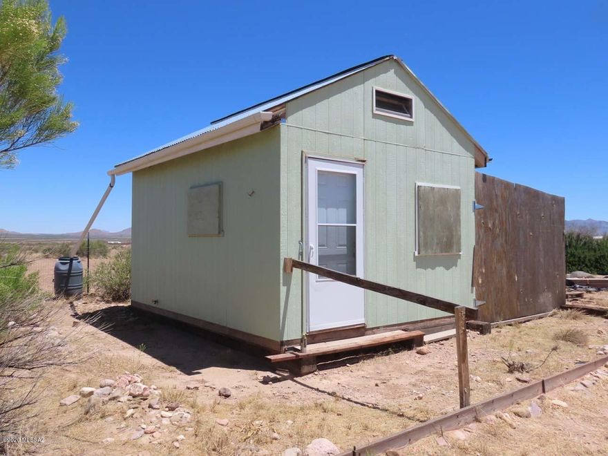 Twenty acres, ready to install manufactured or build! Dark skies! No HOA, no deed restrictions. Good well, septic, electric, & a 12 X 16 house with bathroom and kitchen corner, live in while you build. Water heater needs hooking up, RV hookup. Fruit & shade trees on drip, fenced area for dogs, soil is great for gardening. You can see clear to the 10,000' Pinaleno mts, watch the stars rise in the east. Major shopping: 70 mi to Douglas AZ, 90 to Silver City NM, Safford AZ, 145 to Tucson airport. Verizon & ATT, Portal has medical clinic, EMS, VFD, library, also local post offices, cafes, convenience stores;  hardware & gas in Animas & San Simon. Great birding, wildlife viewing, hiking, in cool canyons and high conifer forests of Chiricahuas. Neighbors cooperate to maintain dirt roads