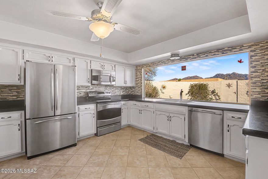 This charming burnt adobe home offers comfortable, low-maintenance living with 2 spacious bedrooms plus a versatile den and 2 full bathrooms in a light-filled, open floor plan. Enjoy Catalina Mountain views from the kitchen, formal dining area, and primary bedroom.
The spacious kitchen features granite countertops, stainless steel appliances, and ceramic tile flooring, while the living areas open to a covered brick-paver patio, ideal for relaxing or entertaining. Additional highlights include tile flooring, a cozy fireplace, ceiling fans, ample storage, and low-care landscaping.
Situated on a quiet cul-de-sac with two covered parking spaces and access to community amenities including a pool, spa, this Northeast Tucson home blends classic adobe with everyday ease.